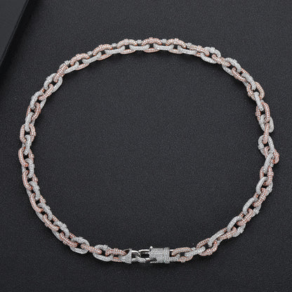 a silver chain with a clasp on a black surface