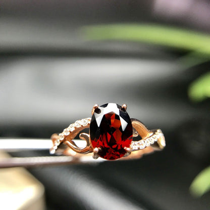 a close up of a ring with a red and white stone