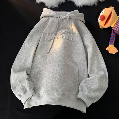 a stuffed animal is next to a sweatshirt