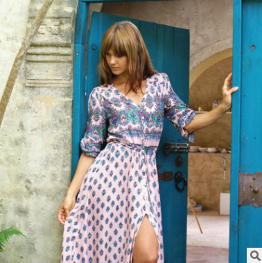 a woman in a dress standing in a doorway