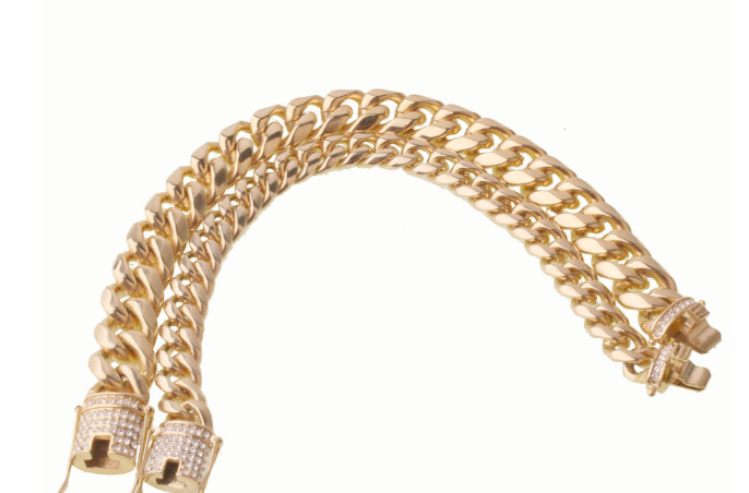 a gold bracelet with a diamond clasp