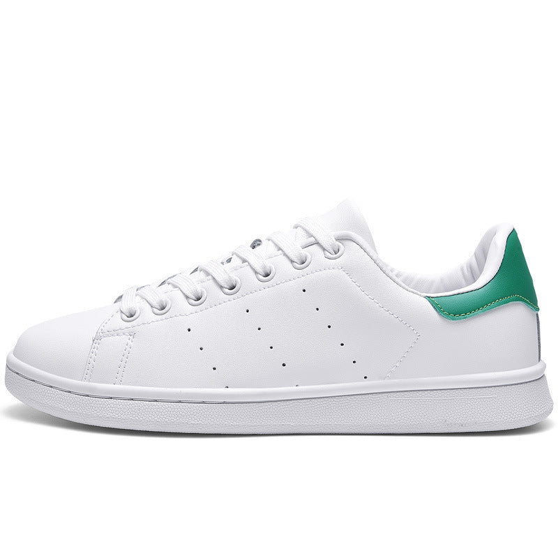 a white and green tennis shoe on a white background