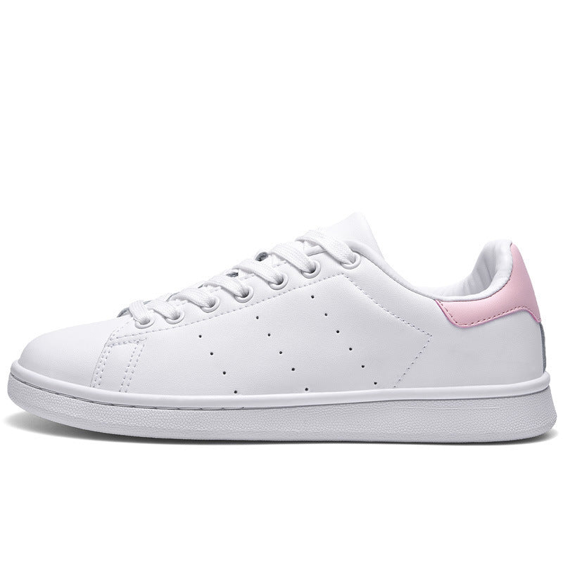 a women's white and pink tennis shoe