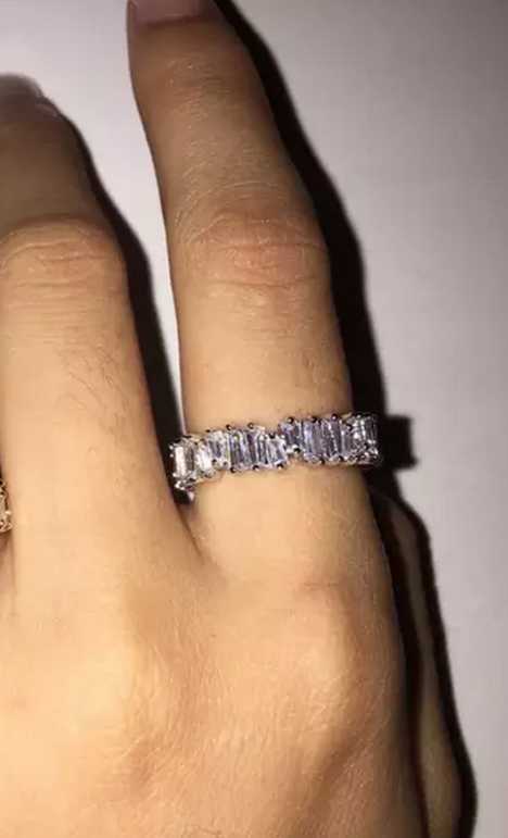 a woman's hand with a diamond ring on it