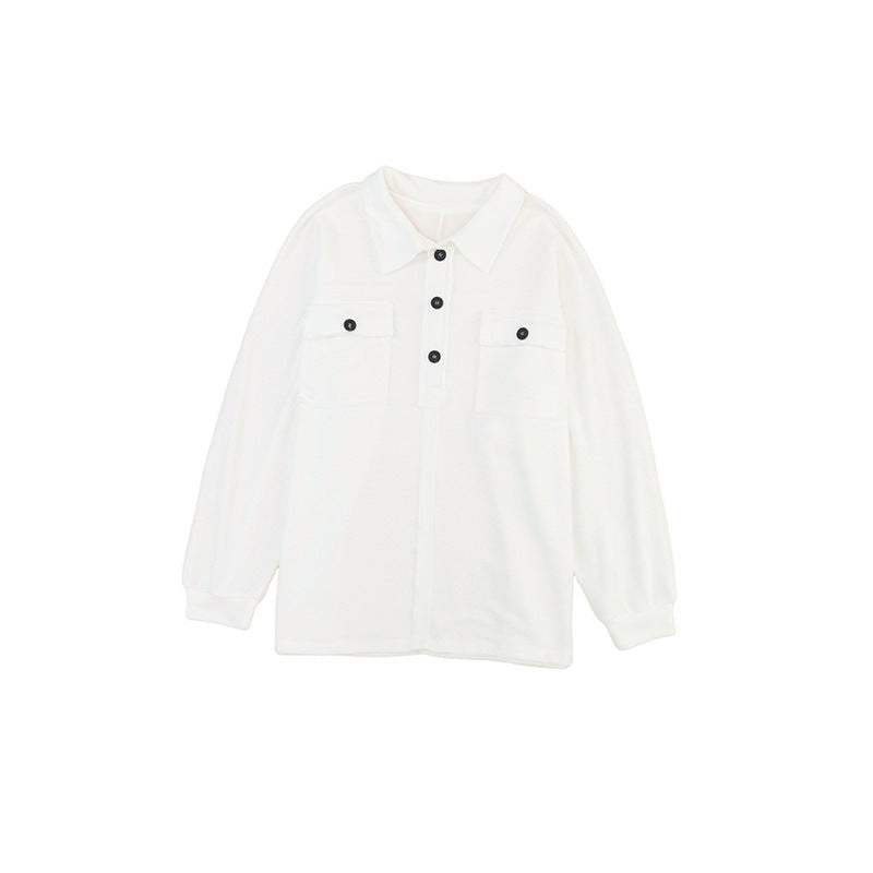 a white shirt with black buttons on the chest