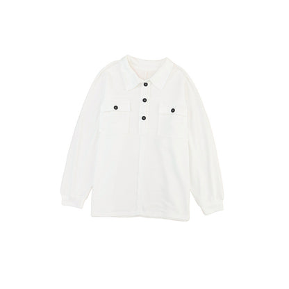 a white shirt with black buttons on the chest