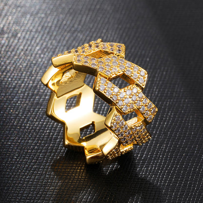 a gold ring with diamonds on a black surface