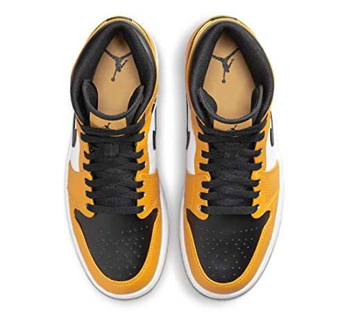 a pair of yellow and black sneakers on a white background