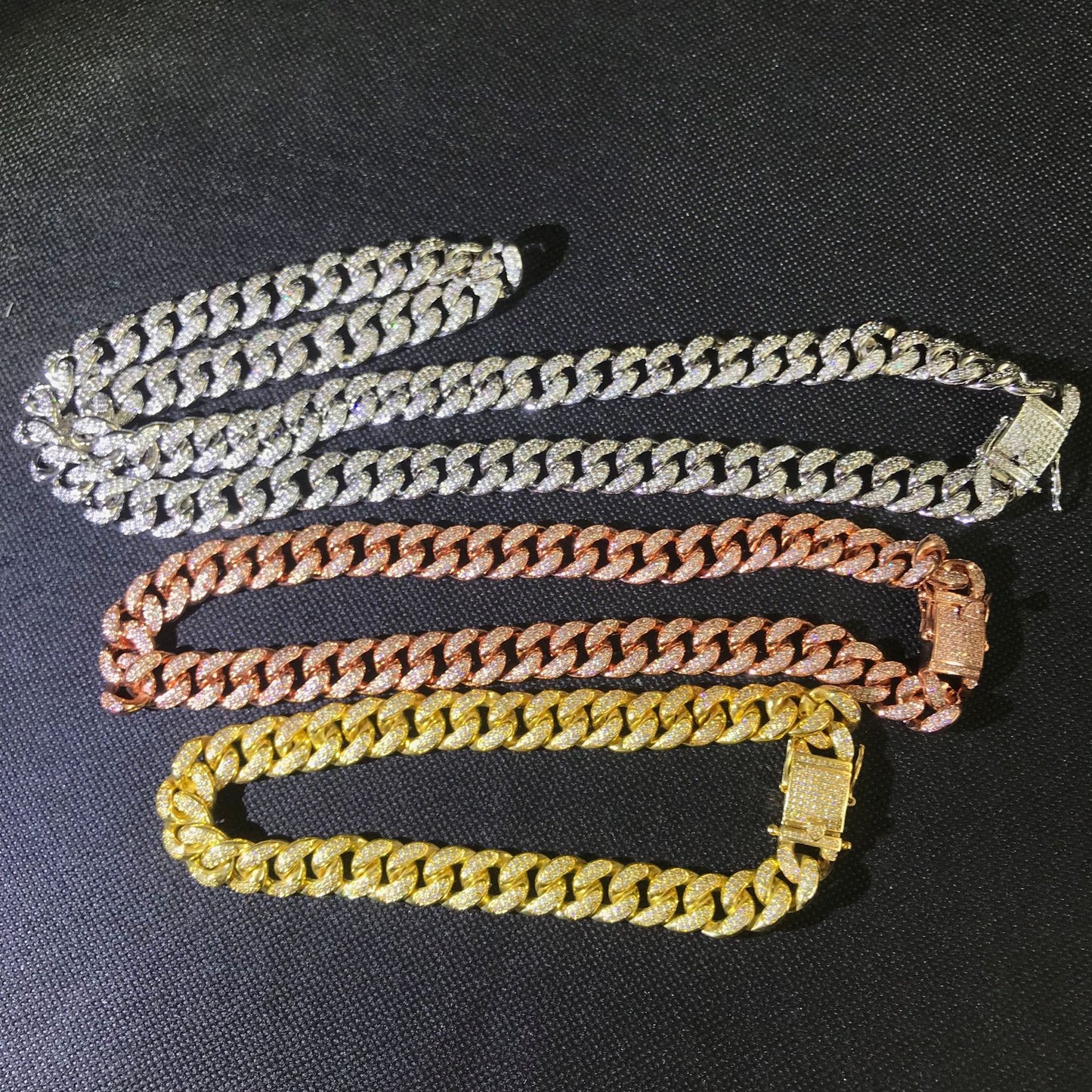 four different colors of chain on a black surface