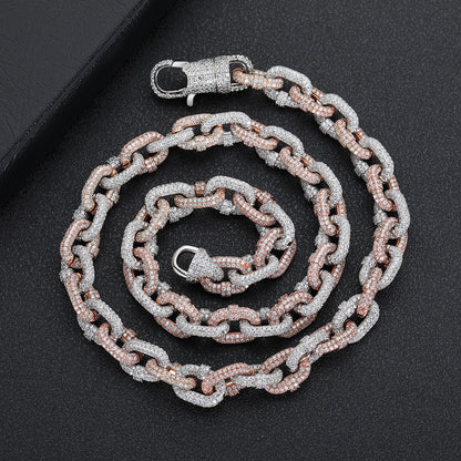 a silver and pink chain with a clasp on a black surface