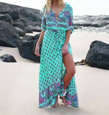 a woman standing on top of a sandy beach