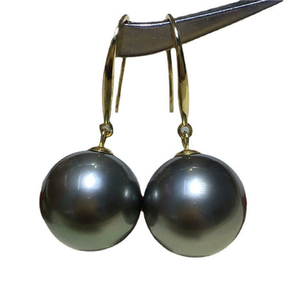 a pair of black pearls hanging from a hook