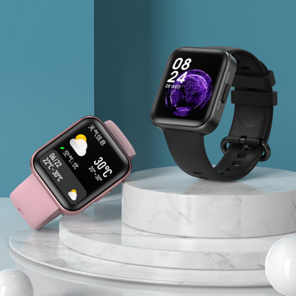 a couple of smart watches sitting on top of a table