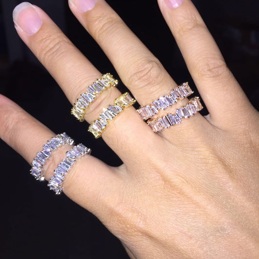 a woman's hand with three different rings on it