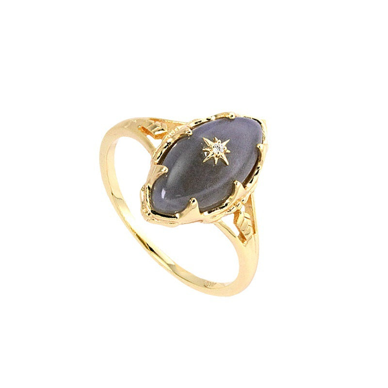 a gold ring with a black stone and a star