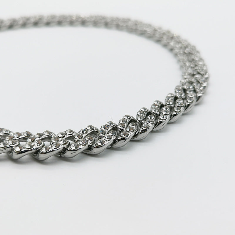 a close up of a chain on a white surface