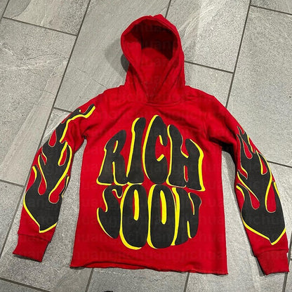 a red hoodie with black and yellow flames on it