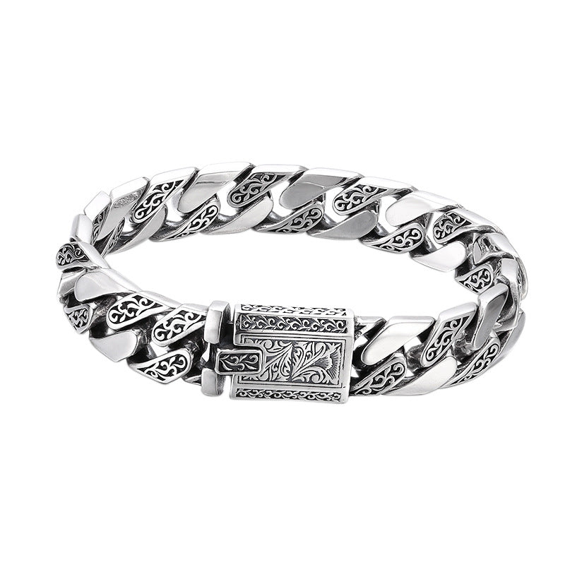 a silver bracelet with a cross on it