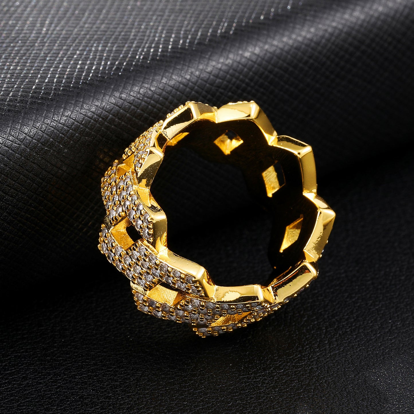 a close up of a gold ring on a black cloth