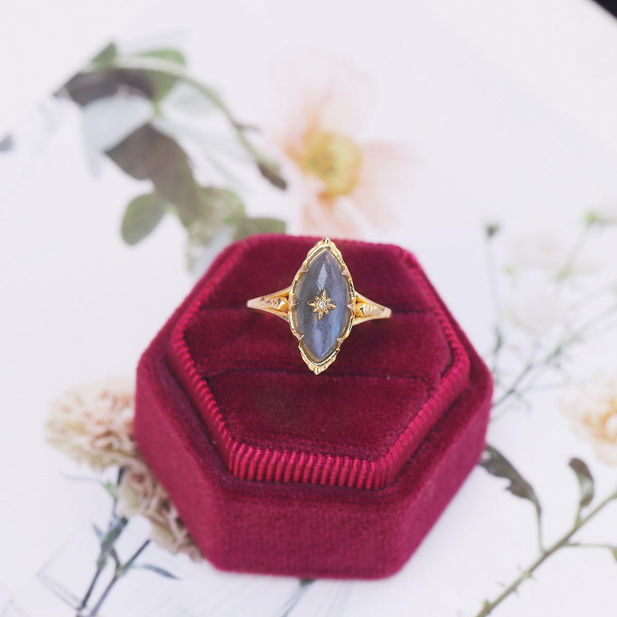 a ring sitting on top of a velvet box