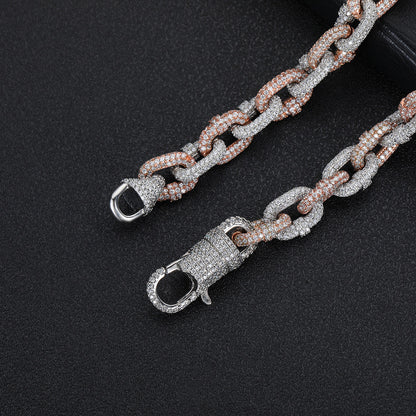a chain with a clasp on a black surface