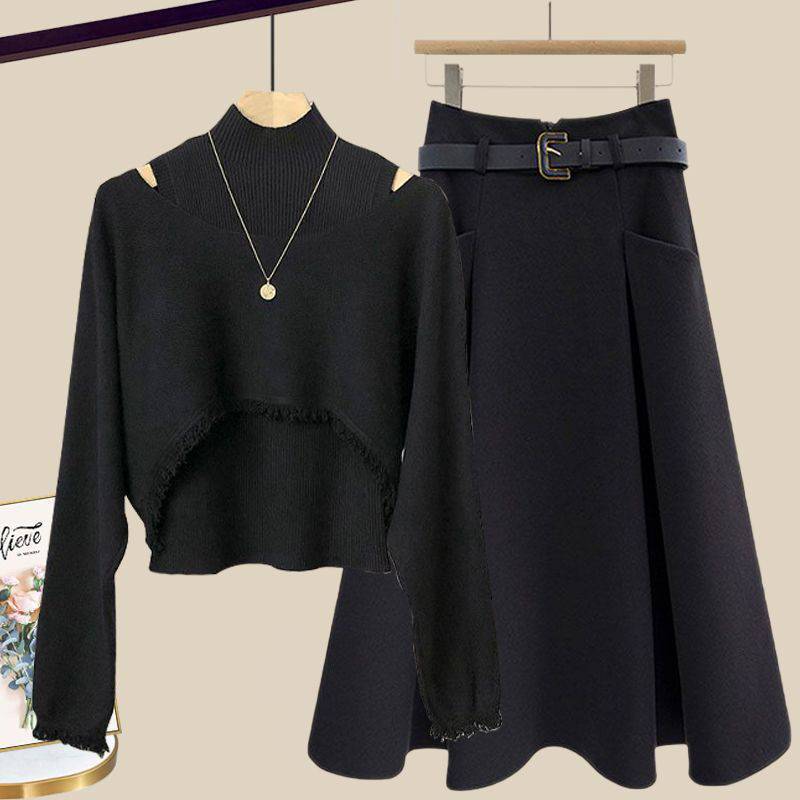 a black sweater and a black skirt hanging on a rack