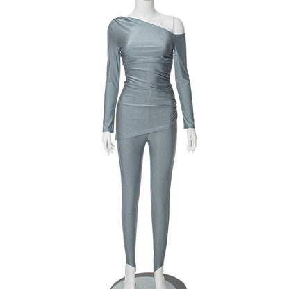 a female mannequin wearing a silver one shoulder top and pants