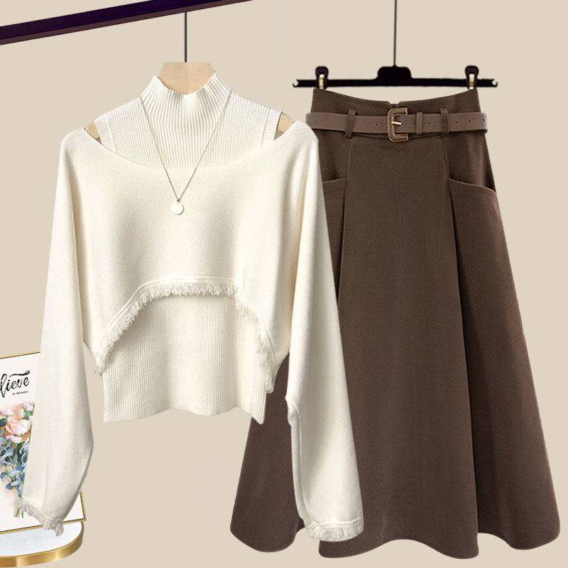 a white sweater and brown skirt are hanging on a rack