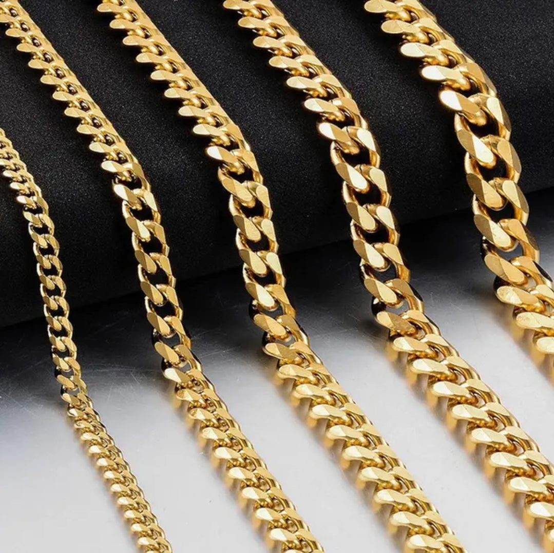 a row of gold chains sitting on top of a table