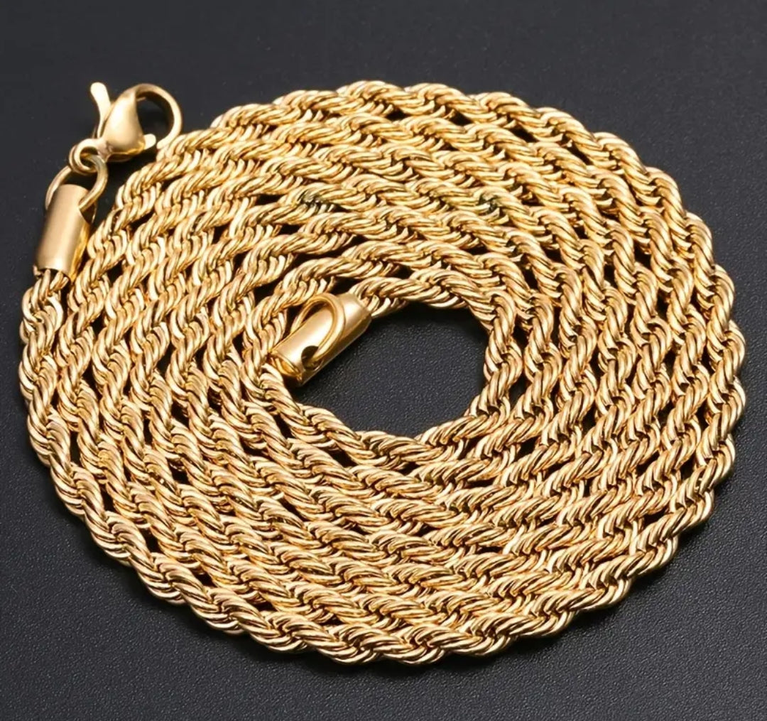 a gold chain is shown on a black surface