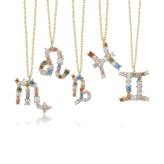 a group of three necklaces with letters on them