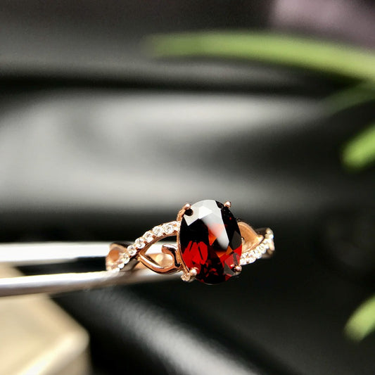 a close up of a ring with a red and white stone