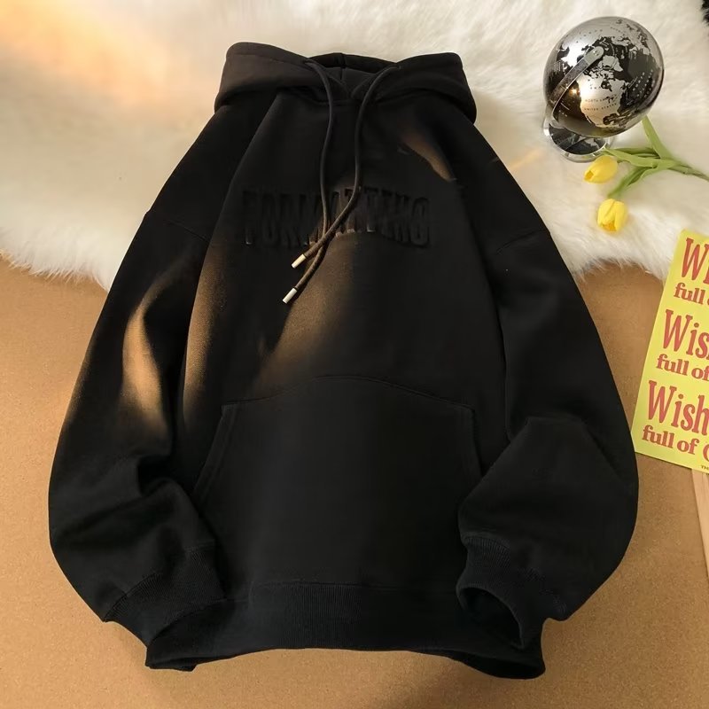 a black hoodie sitting on top of a table