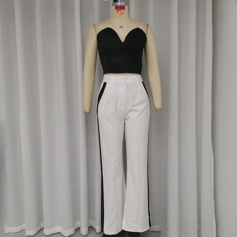 a mannequin with a black top and white pants