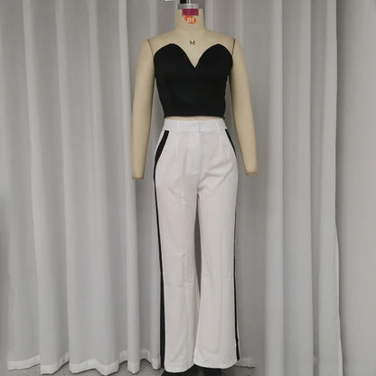 a mannequin with a black top and white pants