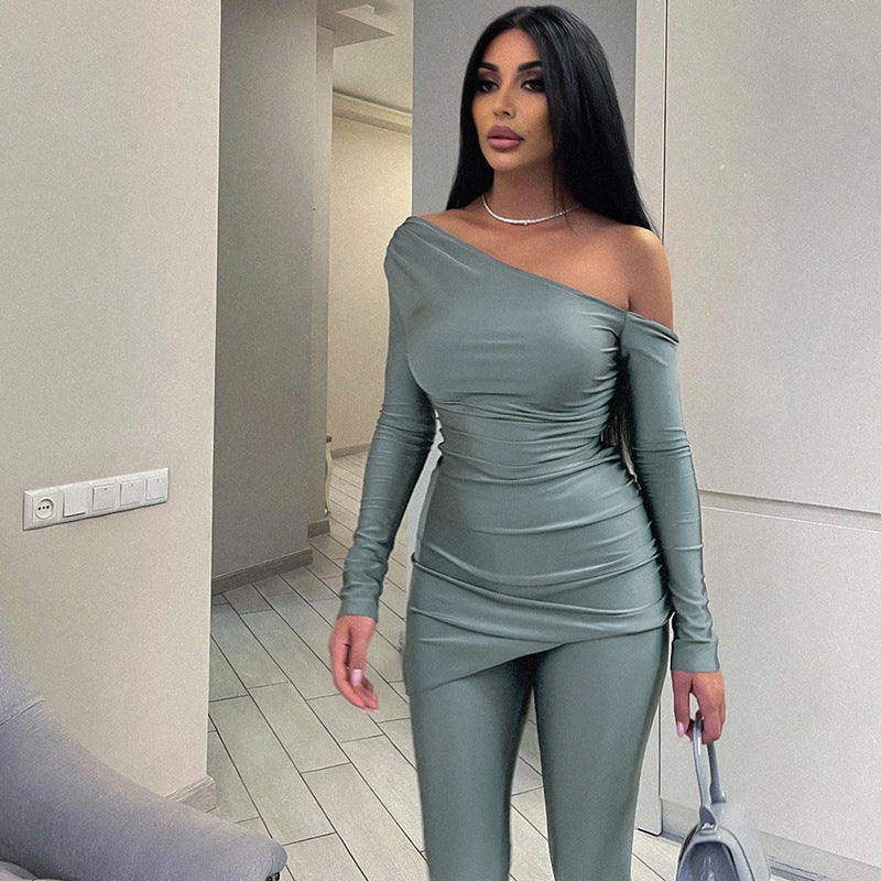 a woman in a grey outfit is walking down a hallway