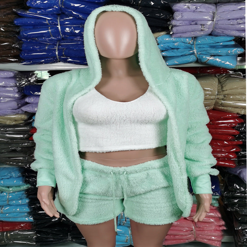 a mannequin wearing a green jacket and shorts