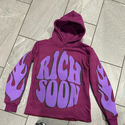 a purple hoodie with purple flames on it