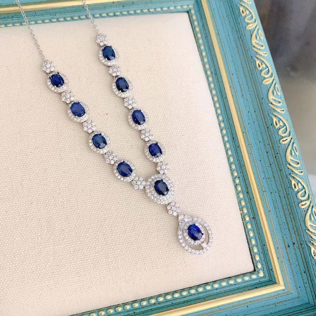a picture frame with a blue and white necklace