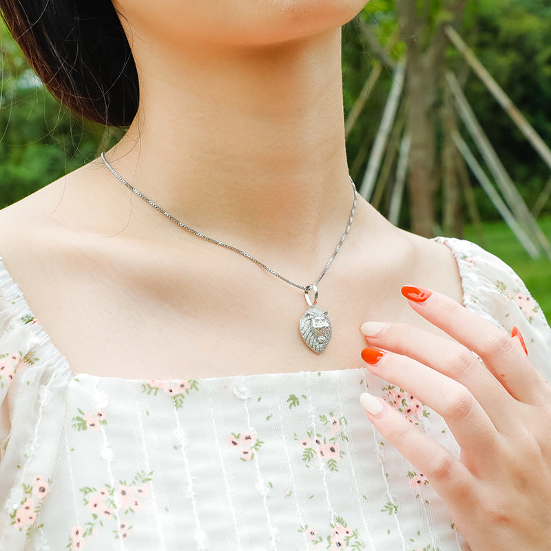 a woman wearing a necklace with a shell on it
