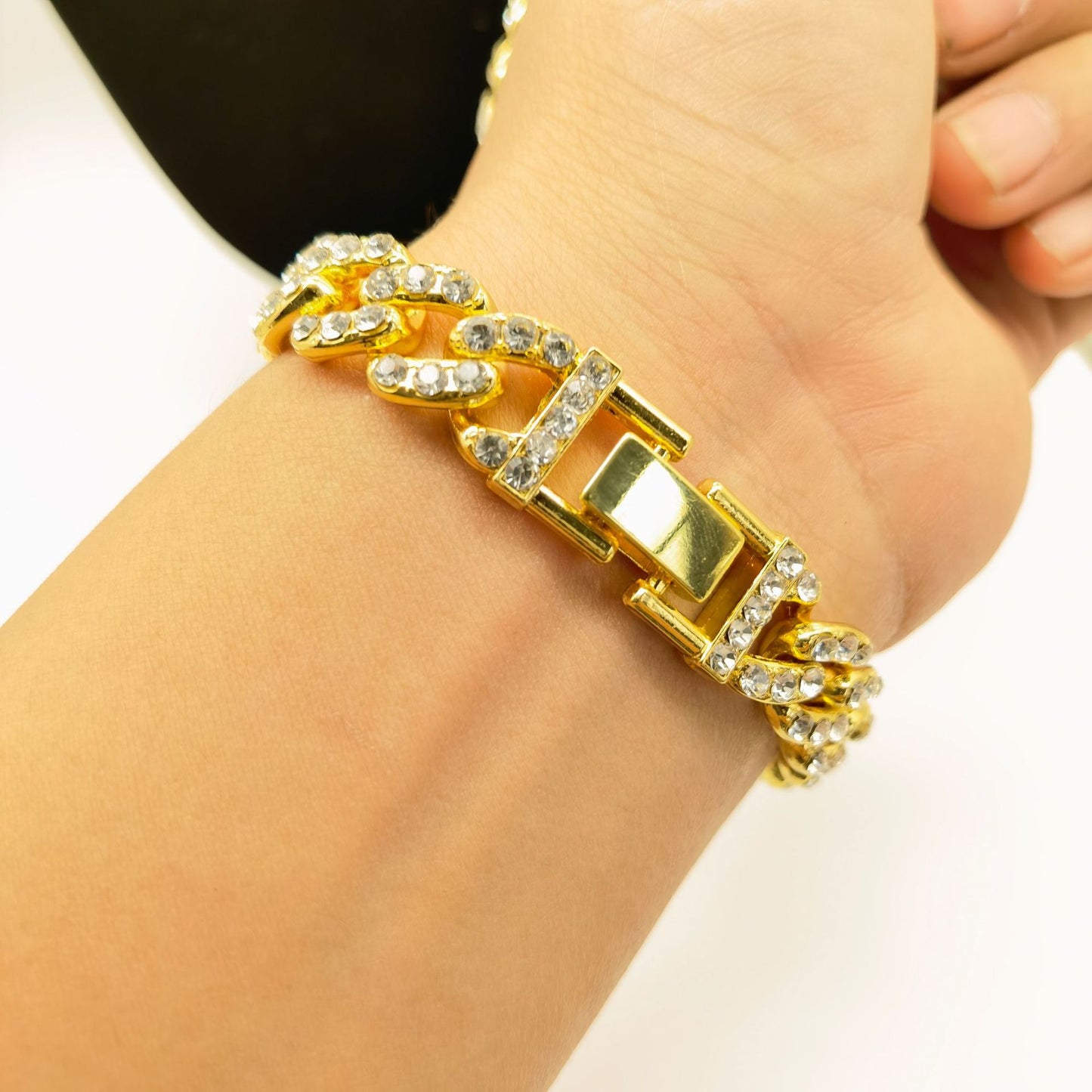 a woman's arm with a gold and diamond bracelet