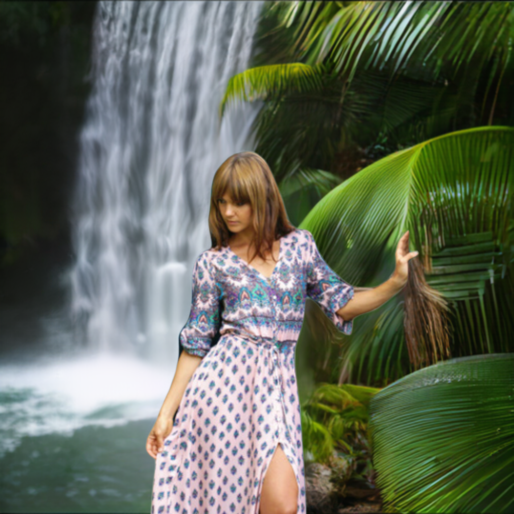 a woman standing in front of a waterfall