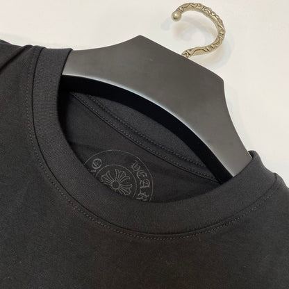 a black t - shirt with a metal hanger attached to it