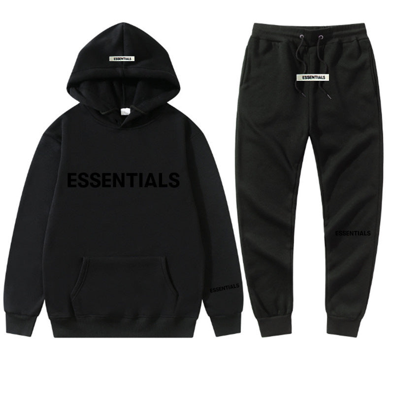 a black hoodie and sweatpants with the words essentials printed on it