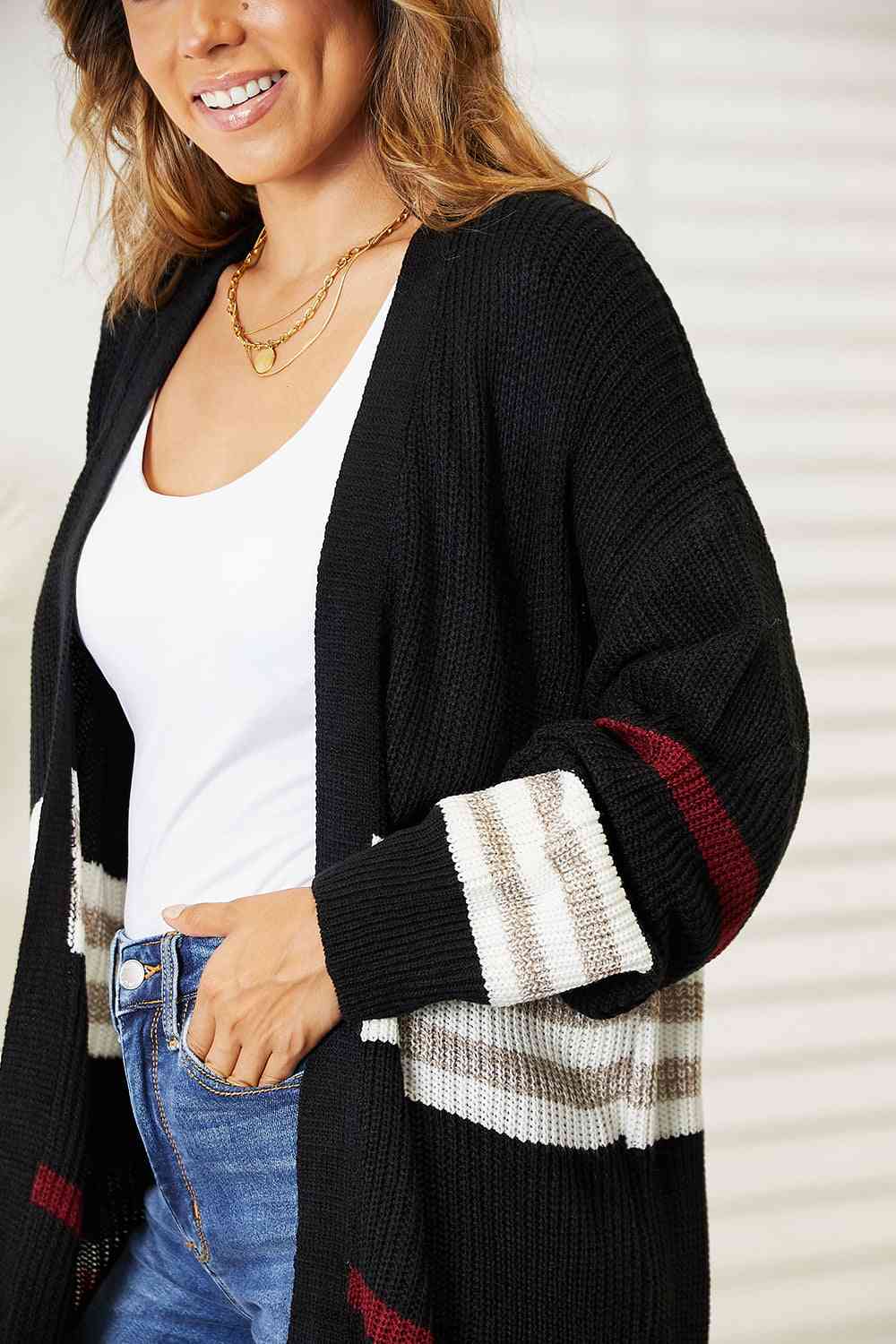 a woman wearing a black and white striped cardigan