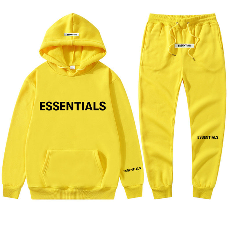 a yellow hoodie and sweatpants with the words essentials printed on it