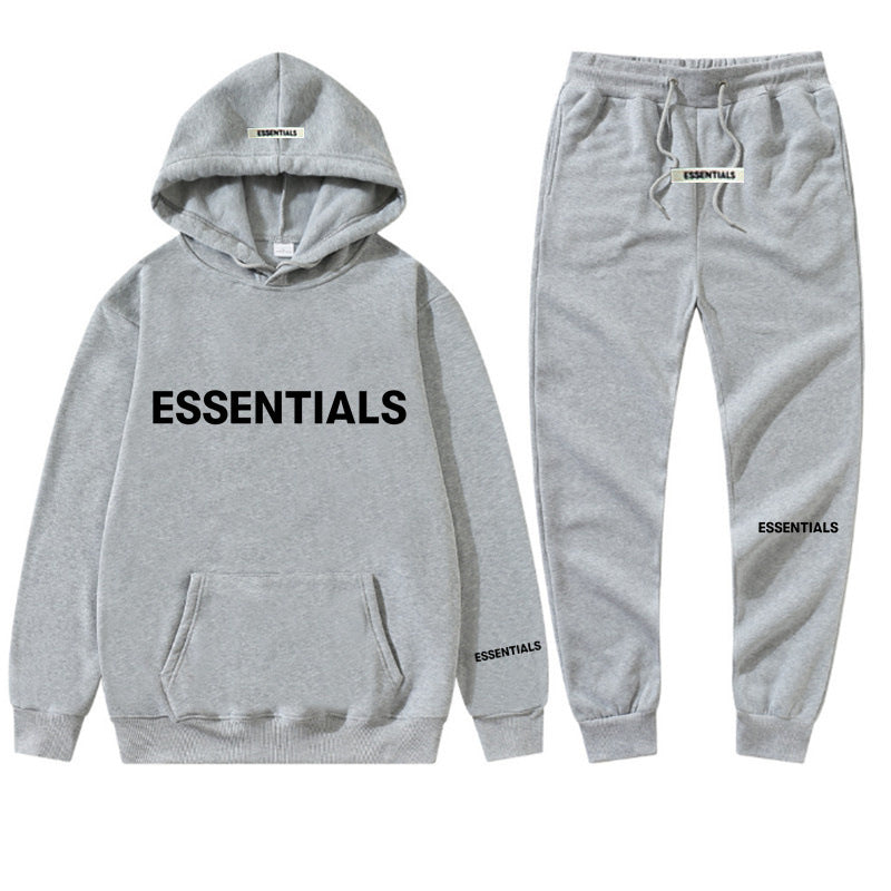 a grey hoodie and sweatpants with the words essentials printed on it