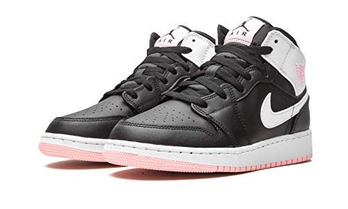 a pair of black and white sneakers with pink soles