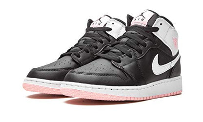 a pair of black and white sneakers with pink soles