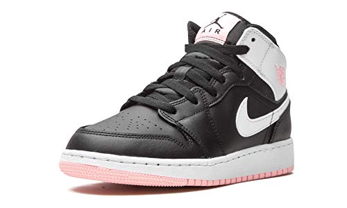 a pair of black and white sneakers with pink soles